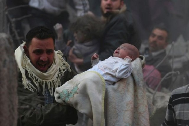 Baby recovered from rubble as Syrian tyrant Bashar Assad bombs his own people